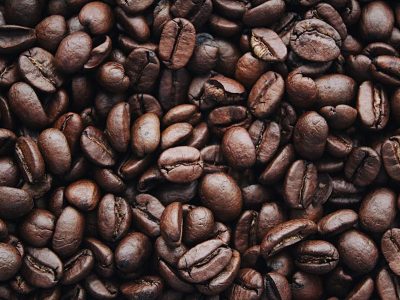 A detailed view of aromatic roasted Arabica coffee beans, highlighting texture and brown color.